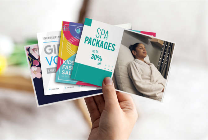 A person holding mailpieces including a discount on spa packages.