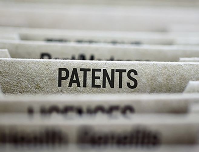 An image featuring multiple files in a filing cabinet, with one of them being clearly labeled as “Patents”.