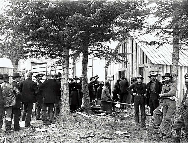 A black-and-white photograph of a crowd of men lined up at a Post Office™ location.