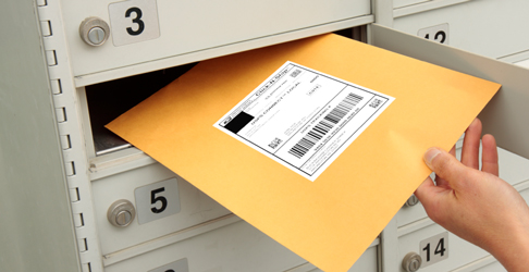 USPS Connect Local Mail envelope being pulled out of a cluster unit box.