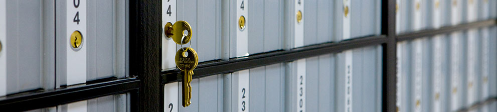 A set of keys hanging from a USPS PO Box.