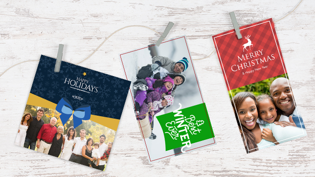Various custom holiday cards on a workshop table.