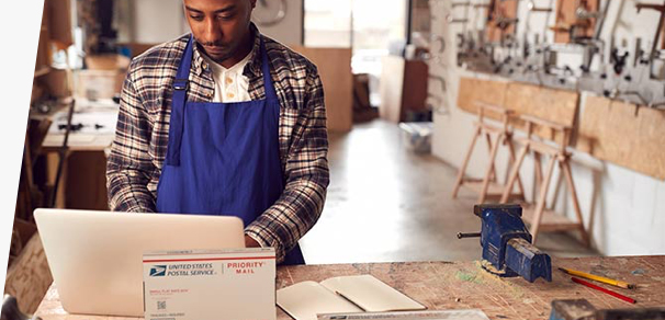 Small business owner preparing to ship Priority Mail packages.