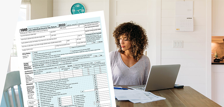 Woman doing taxes with computer, IRS form 1040, and USPS Priority Mail envelope.