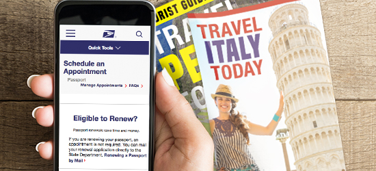 Image of a hand holding a smartphone with the Schedule an Appointment application open with travel magazines on a table.