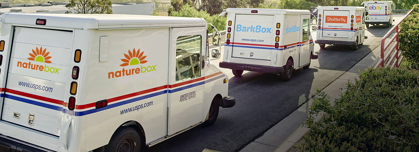 Image of a series of mail trucks with different vendors on them.