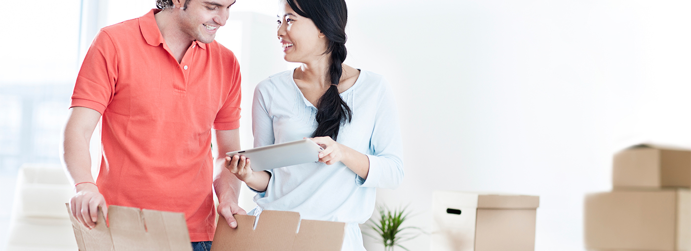 Image of the man and woman looking at a mobile device with boxes around them.