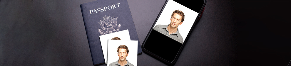 A desk containing a U.S. passport, 2 passport photos, and a digital version of the passport photo on a phone.