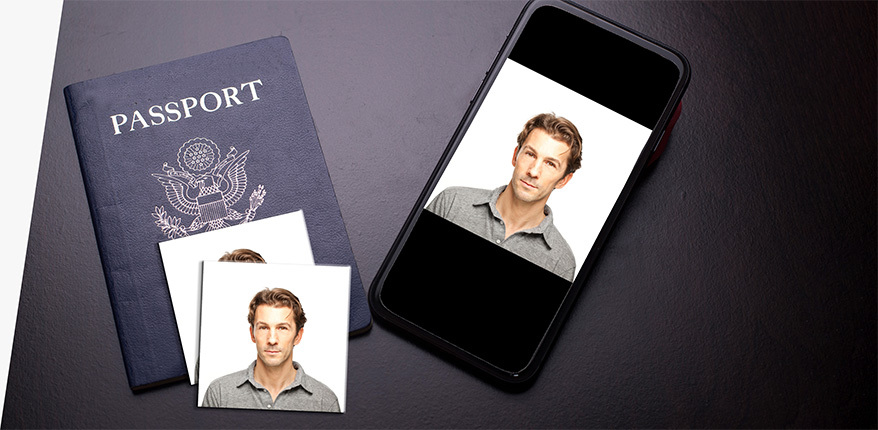 A desk containing a U.S. passport, 2 passport photos, and a digital version of the passport photo on a phone.