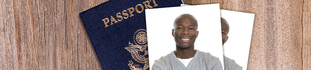 Passport cover and passport photo on desk.