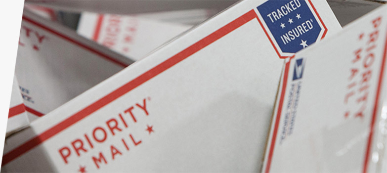 Image of priority mail boxes stacked on top of one another.