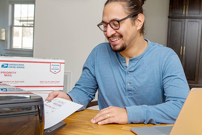 A person printing out a Click-N-Ship label.