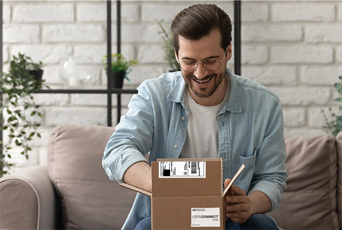 A man opening a package with a Connect Local label on it.