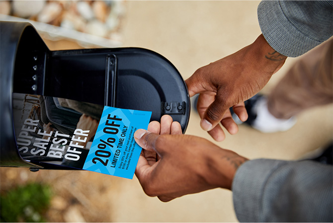 A person viewing delivered mail pieces.