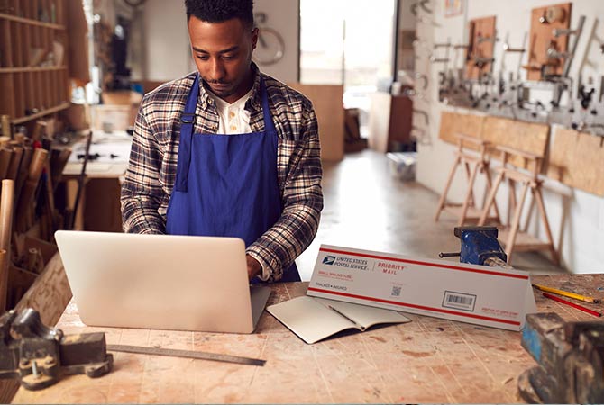 Small Business owner preparing to ship a Priority Mail package.