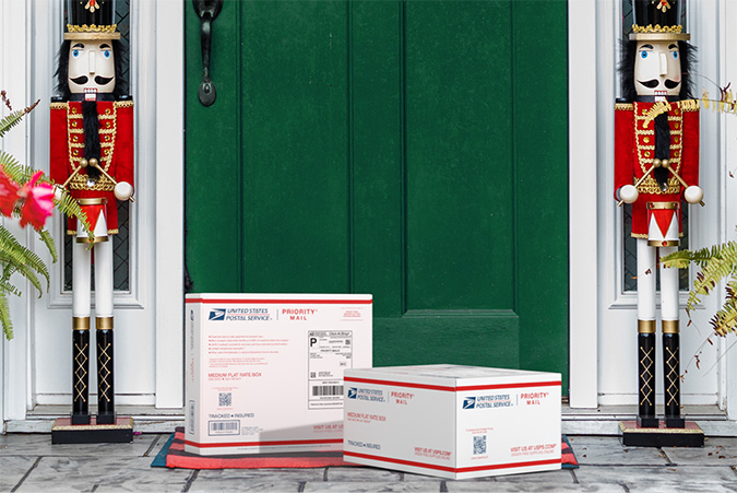 Priority Mail boxes on a house porch awaiting pickup.