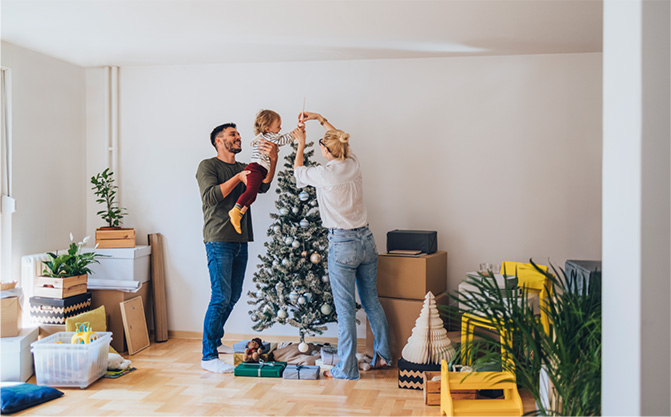 A family putting the final touches on their family holiday tree.