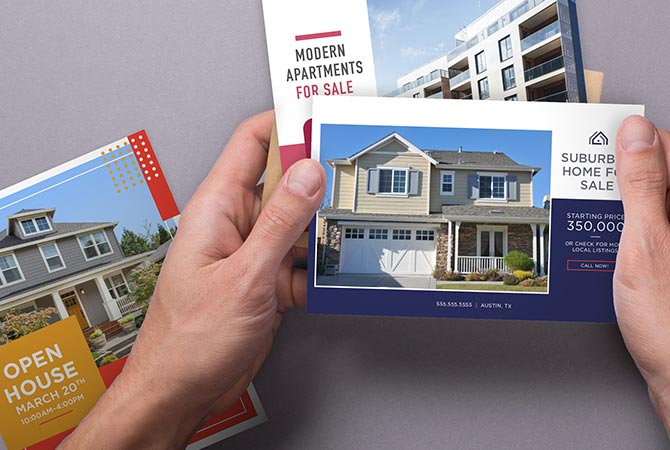 Marketing flyers being held by a person.