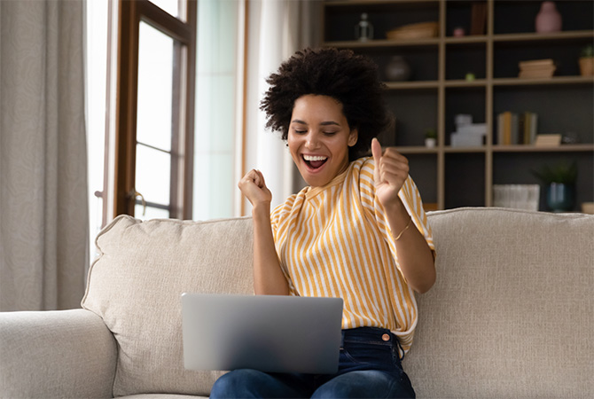 Person celebrating on couch.