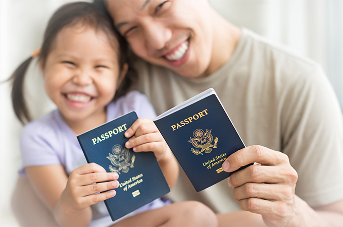 Two family members holding up passports.