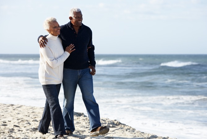A couple walking along the beach.