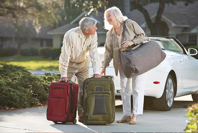 Man and woman with luggage preparing for trip.