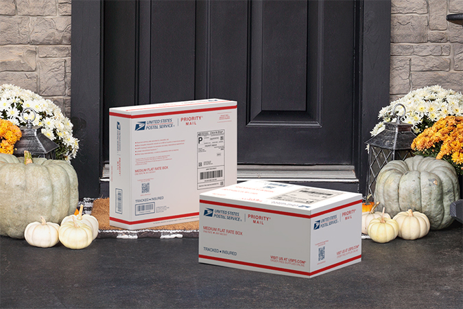 Priority Mail boxes on a house porch awaiting pickup.