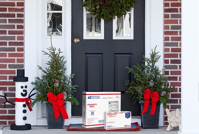 Priority Mail boxes on a house stoop awaiting pickup.