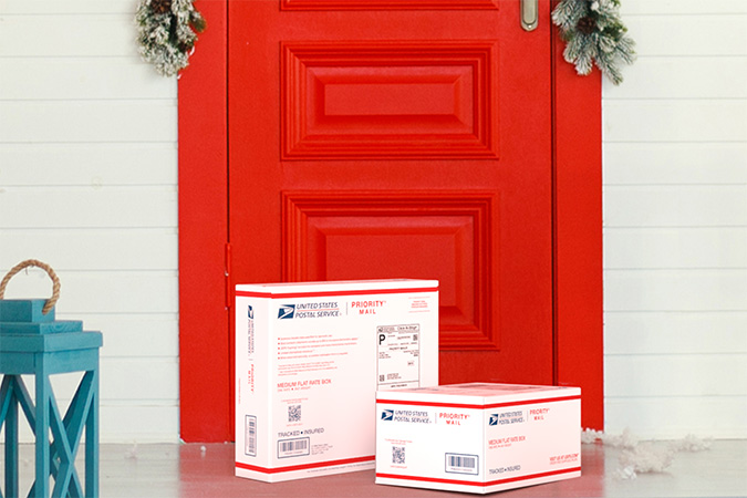 Priority Mail boxes on a house porch awaiting pickup.