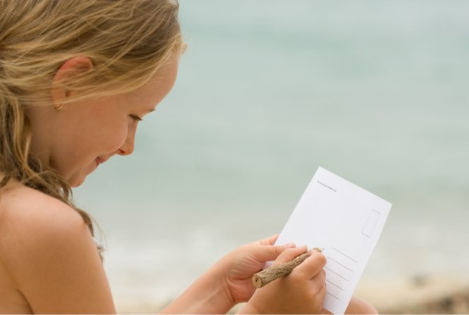 Person addressing postcard.