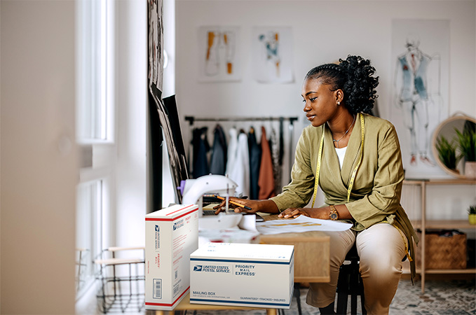 Small Business owner preparing to ship a Priority Mail package.