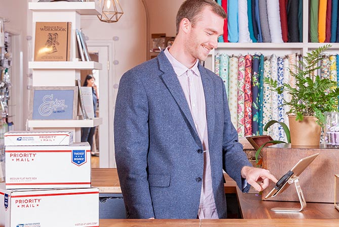 A man preparing to ship packages.