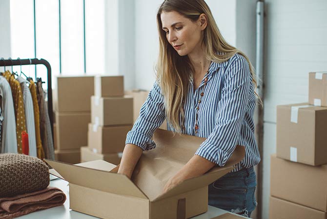 A woman preparing to ship packages.