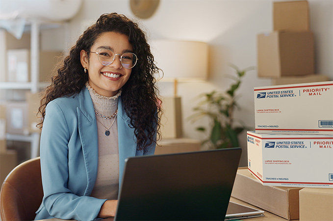 Small business owner with a stack of packages ready for shipment.