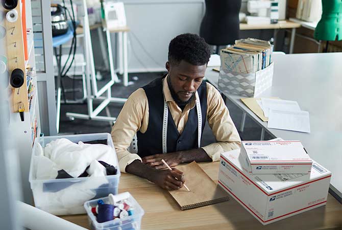 Small business owner with a stack of packages ready for shipment.