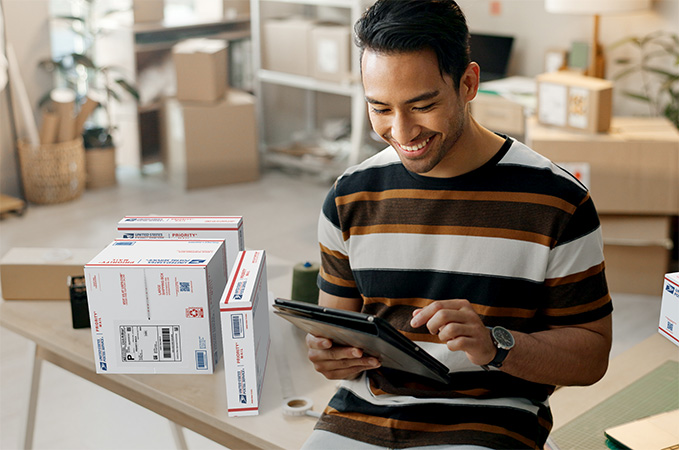 Small business owner with a stack of packages ready for shipment.