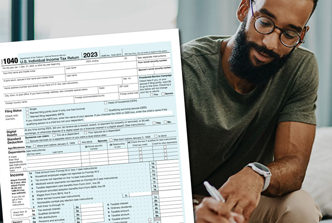 Person doing taxes on table and an IRS form 1040.