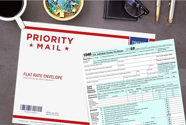 A 1040 tax return form and Priority Mail envelope on an office desk.