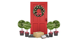 A red door surrounded by holiday decorations with packages awaiting pickup in front of it.