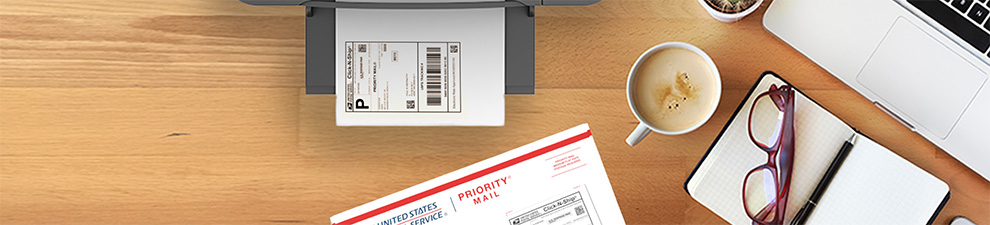A shipping label on a printer and a Priority Mail shipping box sitting on a desk.