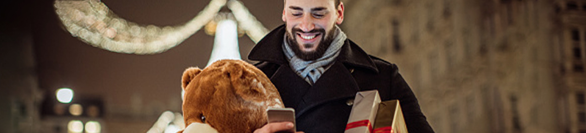 A person carrying gifts while tracking packages with the Informed Delivery application.