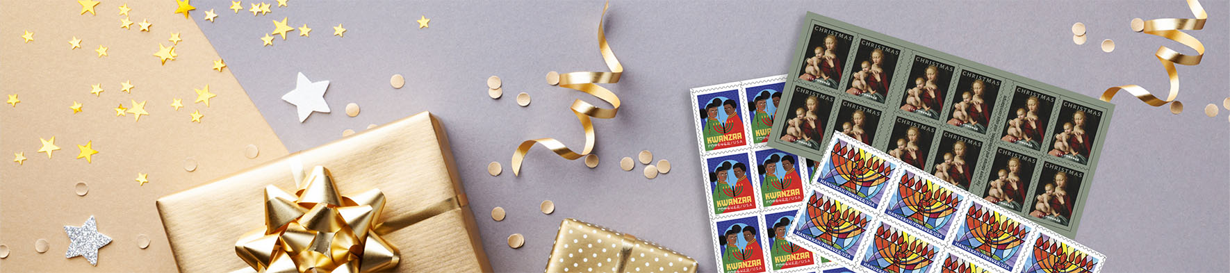 Holiday gifts and holiday themed stamps on a desk.