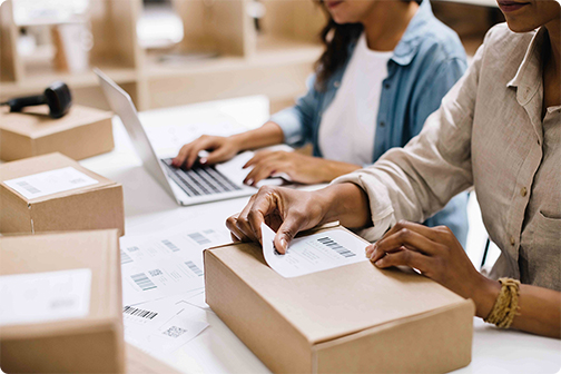 People printing out and placing labels on packages.
